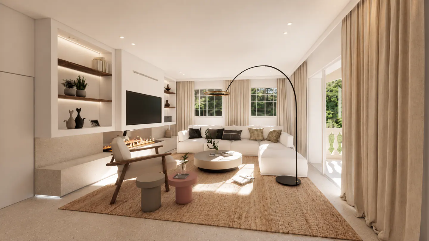 Bright living room with a white sectional sofa, a fireplace, and a large brown rug. A black arched floor lamp stands near the balcony door.