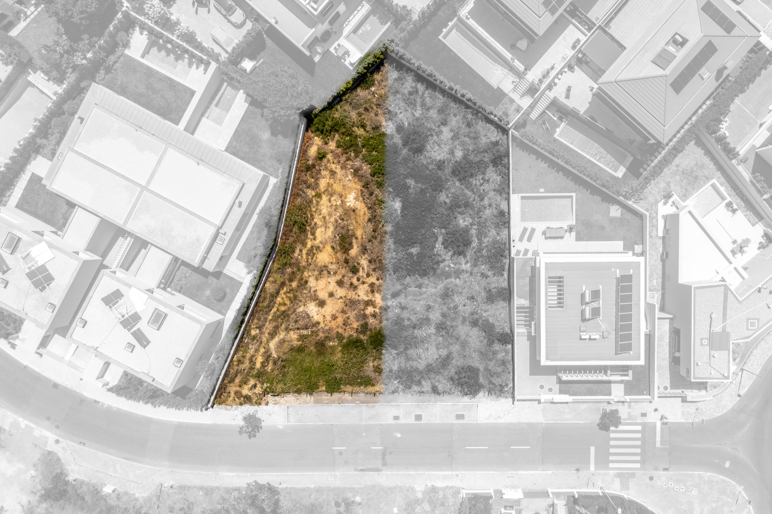 Aerial view of a vacant, triangular residential lot highlighted against a grayscale neighborhood map. [AI-generated text]