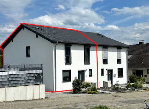 Exterior view of a two-story white townhouse with a dark gray roof, black framed windows and a red outline.