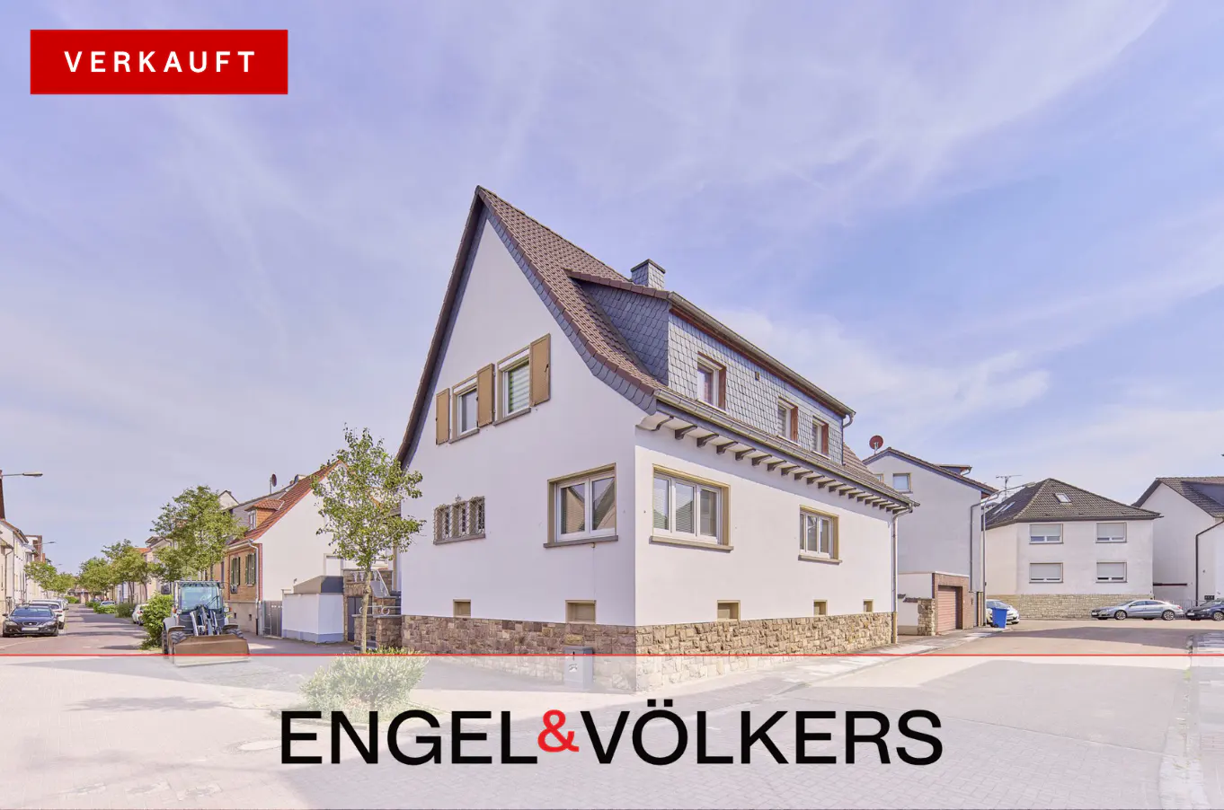 Exterior view of a two-story white house with a gray roof and "VERKAUFT" red banner.