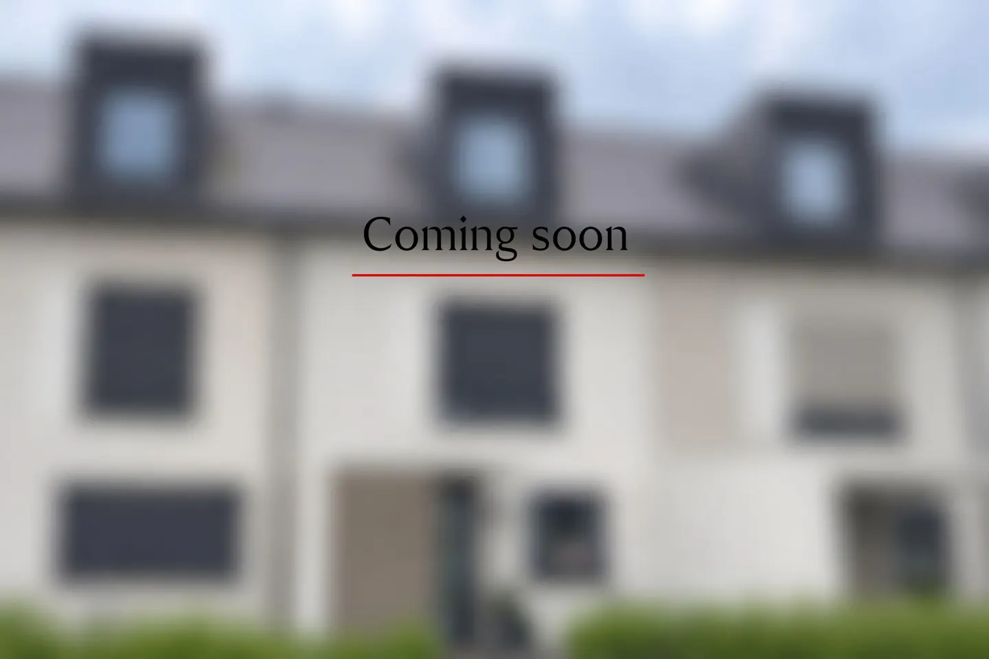 Blurred image of a modern townhouse exterior with the text "Coming soon" overlaid in the center.