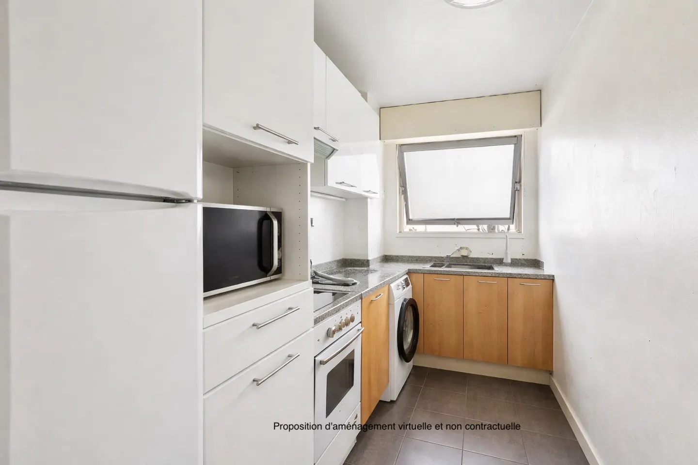 A bright kitchen with white cabinets, a microwave, an oven, and a washing machine. A window is open above the sink.