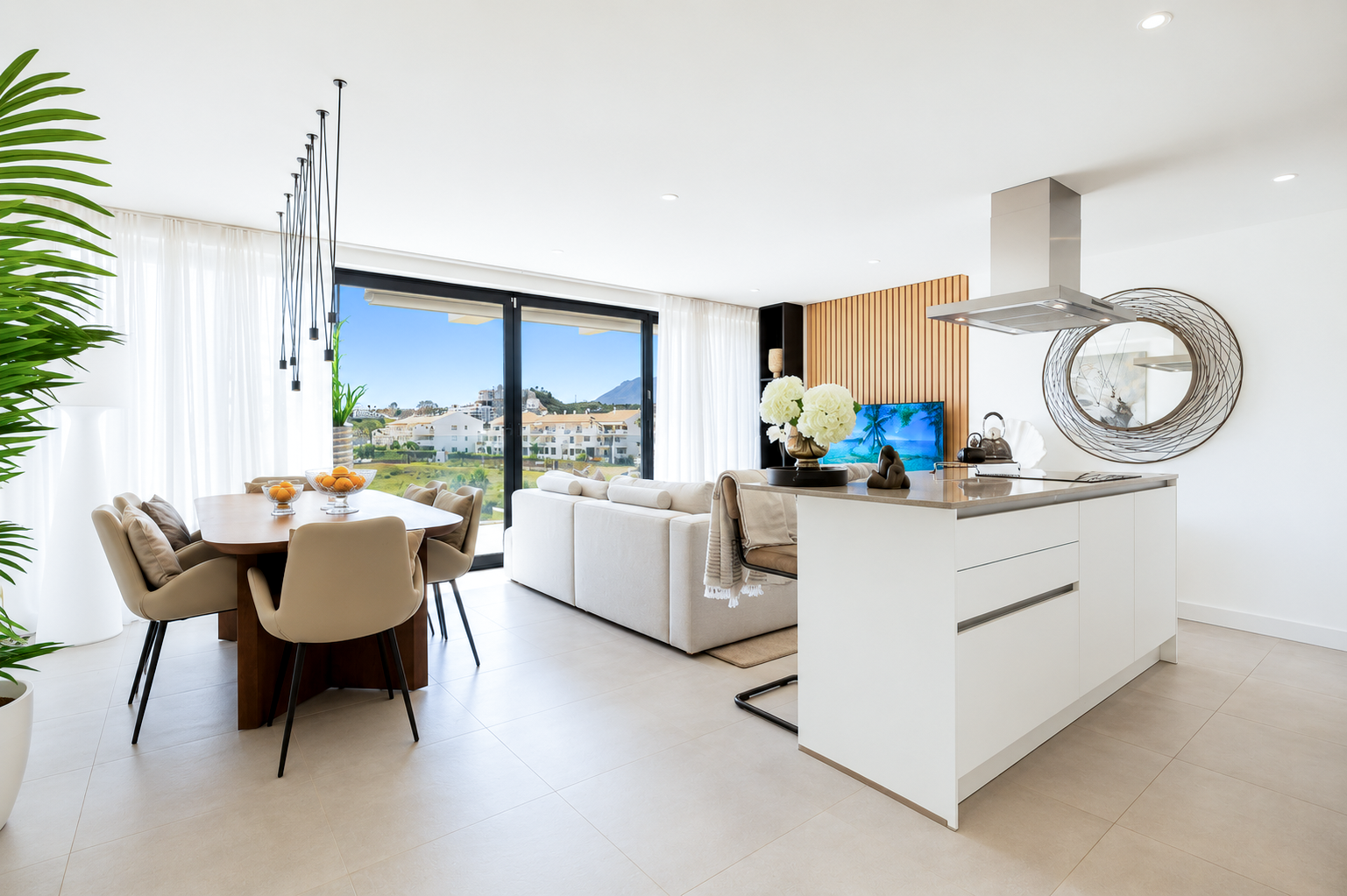 Modern open-plan living area with a dining table, white sofa, kitchen island, and large windows overlooking a sunny landscape. [AI-generated text]
