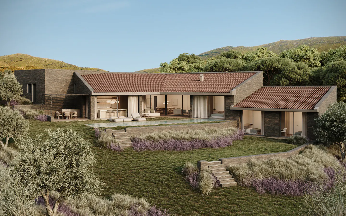 Modern stone house with a red tile roof, large windows, and a pool, set on a grassy hill with lavender and trees.
