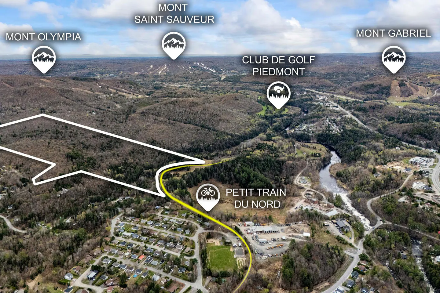 Aerial view of a wooded area with mountains labeled Mont Olympia, Saint Sauveur, and Gabriel. A yellow line marks the Petit Train du Nord trail.