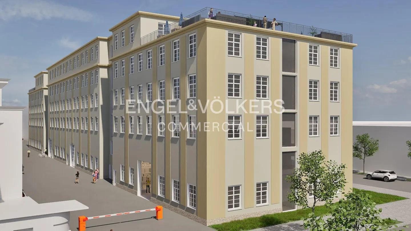 Exterior view of a multi-story commercial building with beige and gray facade, many windows, and the Engel & Völkers logo. People are on the roof.