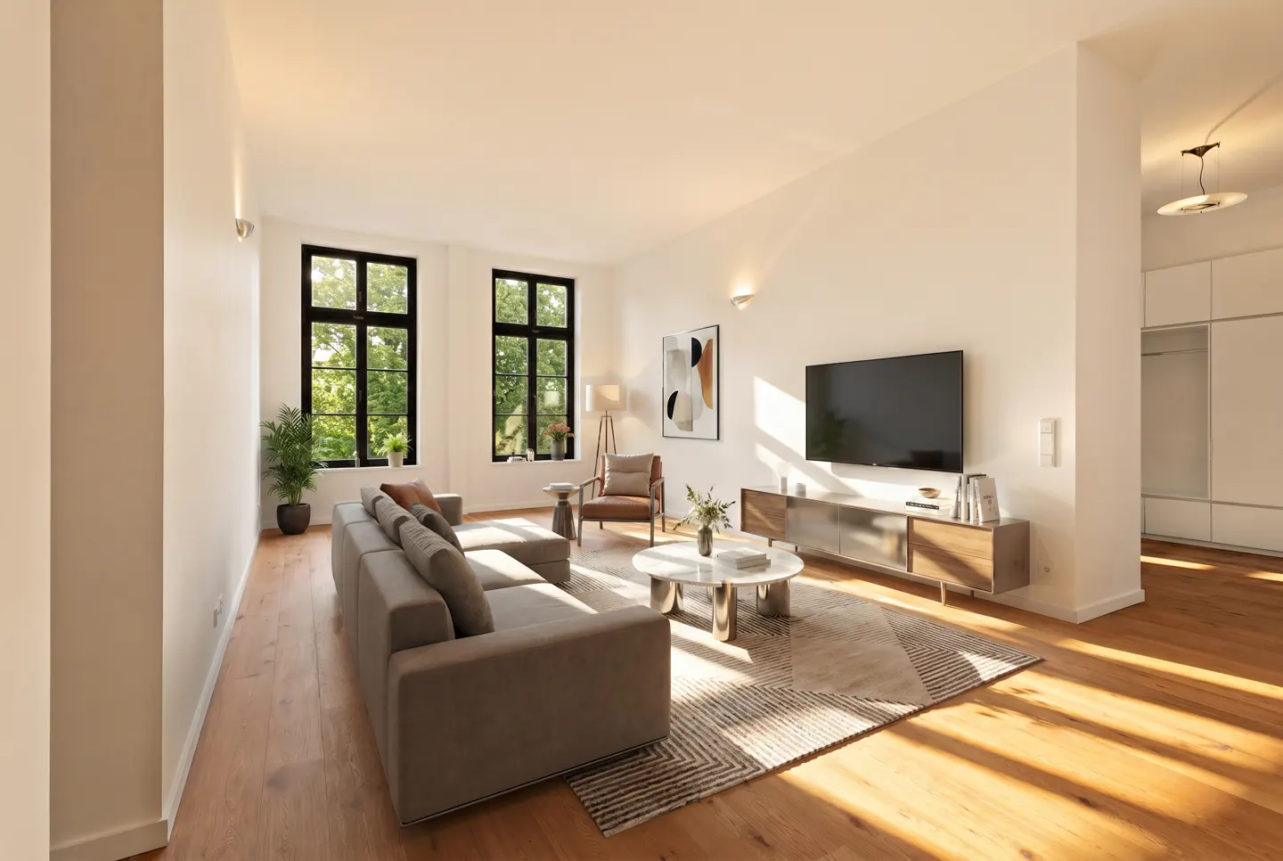 Bright living room with hardwood floors, a gray sectional sofa, and large windows with black frames. A TV hangs above a wooden console.