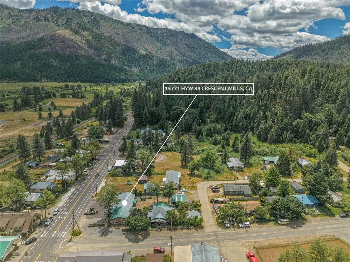 Aerial view of 15771 Hwy 89 in Crescent Mills, CA, featuring a rural property nestled near mountains and pine forests.