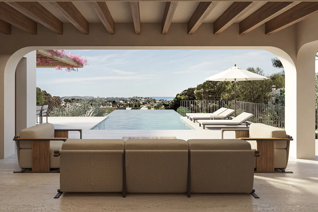 Outdoor patio with beige furniture overlooking a pool, lounge chairs, and ocean view on a sunny day.