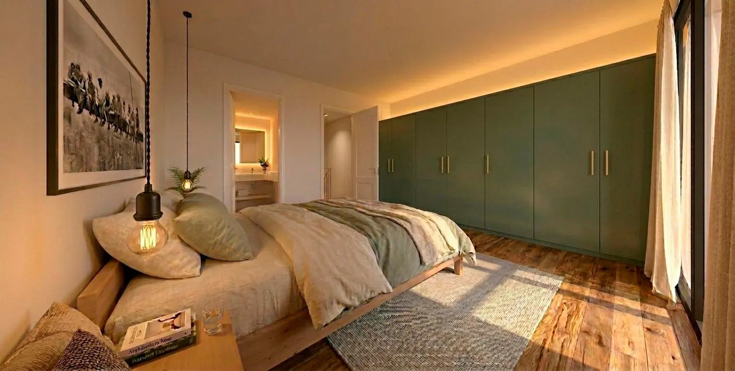 Bedroom with a bed, bedside table, and green closet. A bathroom is visible through a doorway. The floor is wooden.