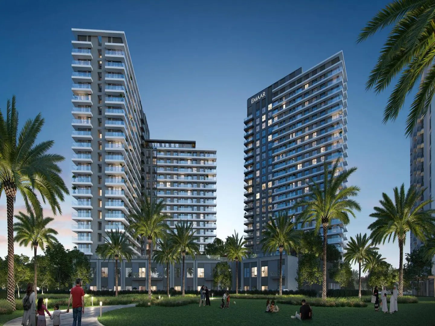 Modern high-rise apartment buildings with balconies, palm trees, and people in a park-like setting. "EMAAR" logo visible.