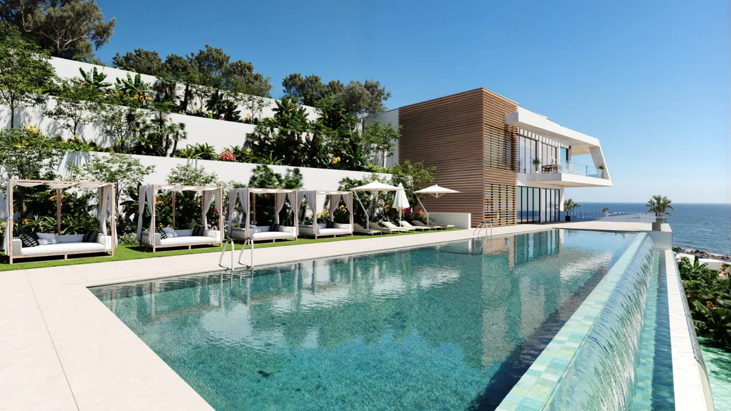 Luxury villa with infinity pool overlooking the ocean. Cabanas line the pool, with tiered gardens on the hillside.