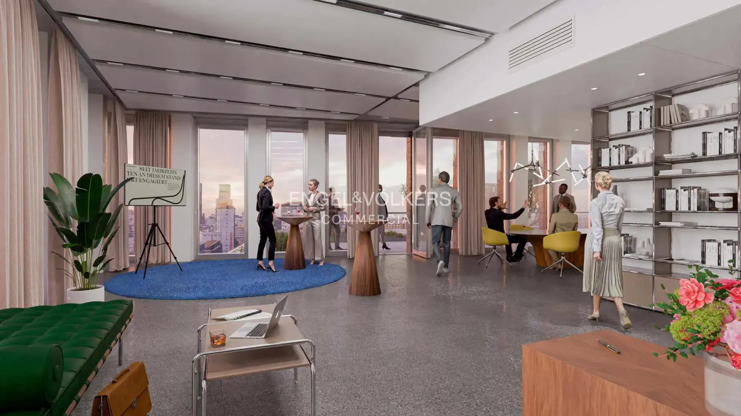 Bright, modern office space with large windows, city views, and people mingling. Features a blue rug, green couch, and a bookshelf.