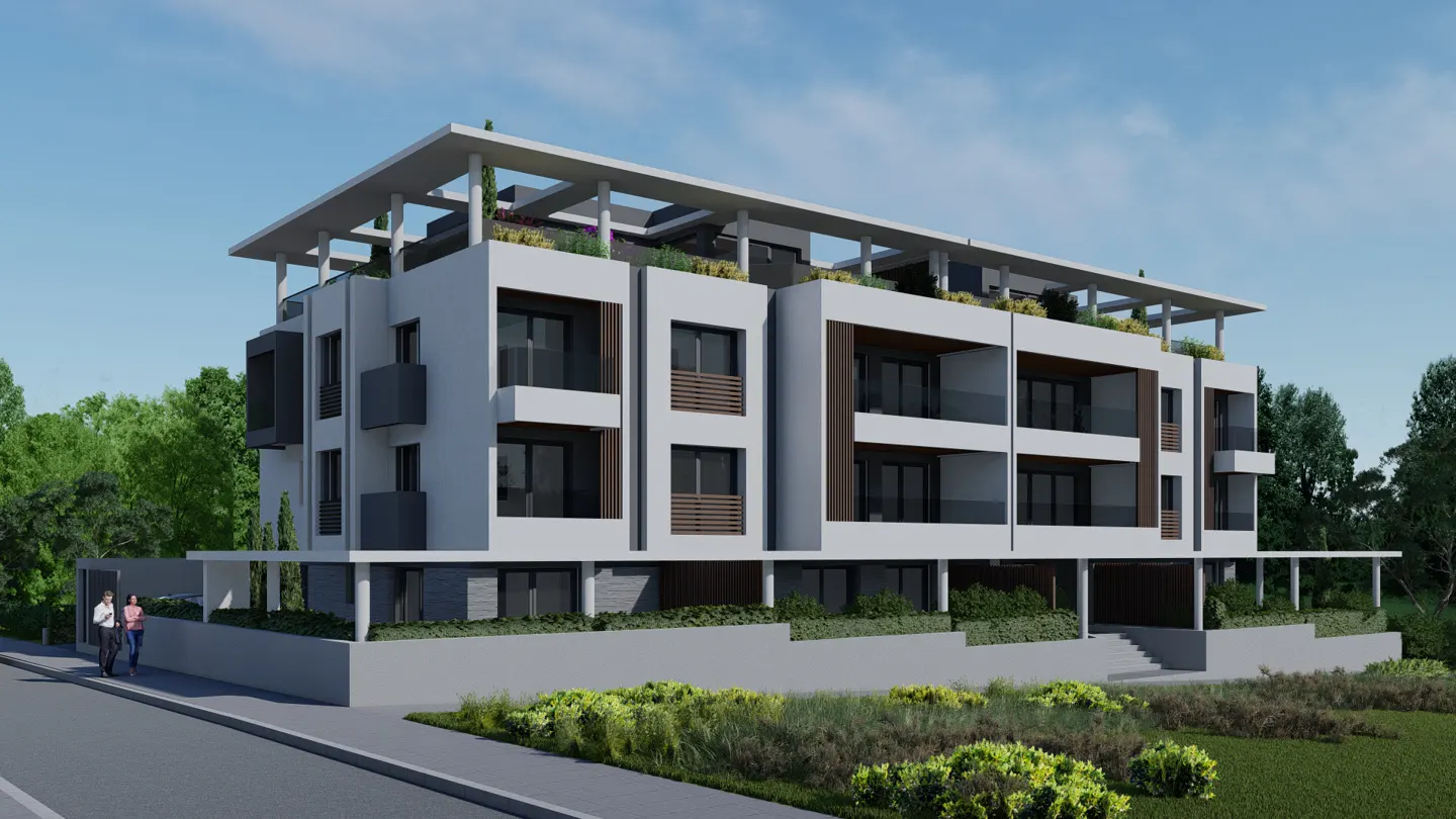 Modern, three-story white apartment building with balconies and a rooftop terrace. Lush greenery surrounds the base, and a couple walks on the sidewalk.