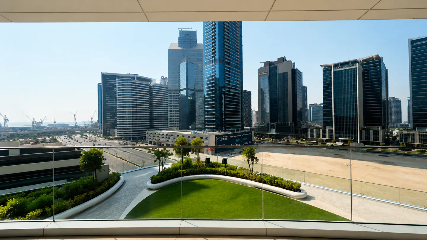 View from a balcony overlooking a green space and a city skyline with tall buildings.