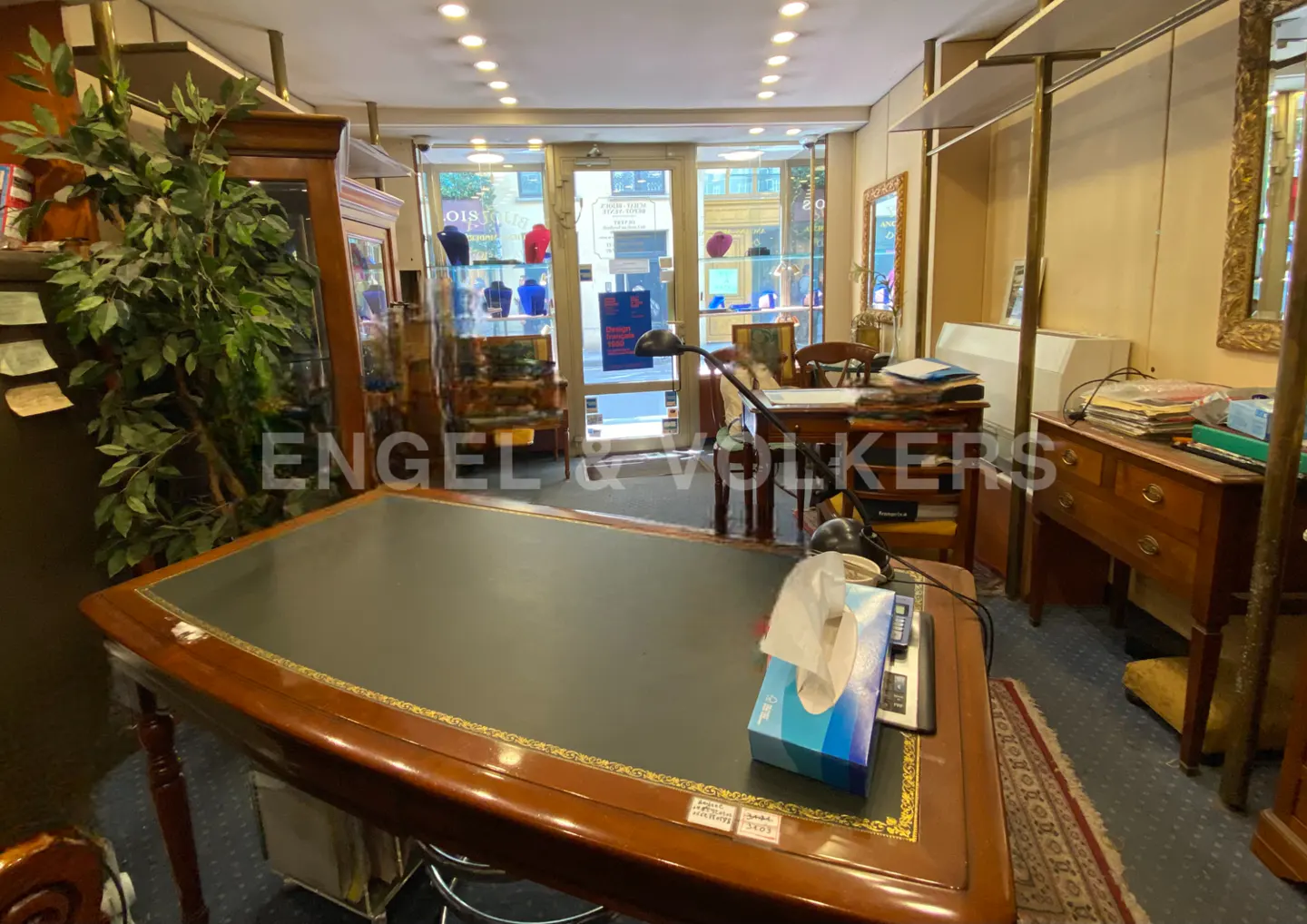 Interior view of a retail space with desks, display cases, and the Engel & Volkers logo.