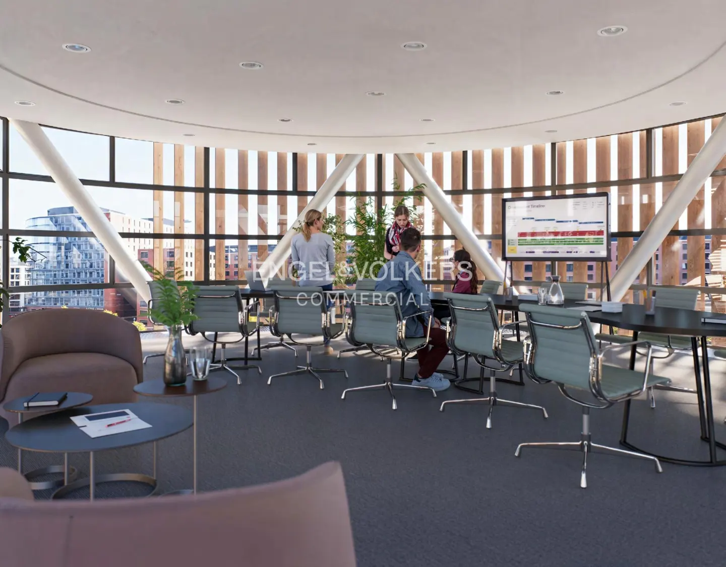 A modern office space with a round design, featuring a conference table, chairs, and a presentation screen. People are gathered for a meeting.