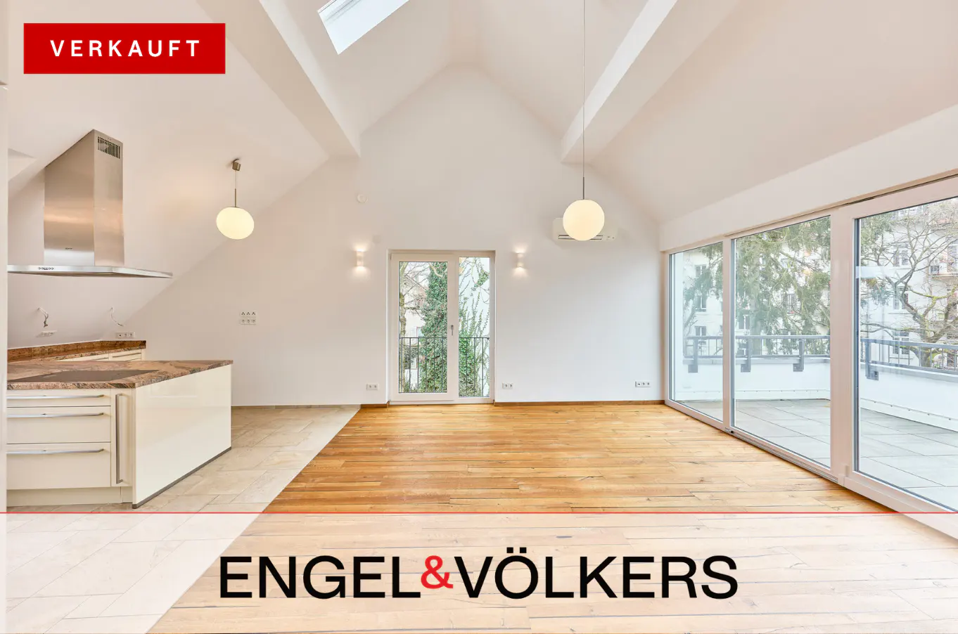 Bright, airy apartment interior with wood floors, white walls, and a modern kitchen. Large windows offer outdoor views. "VERKAUFT" banner.