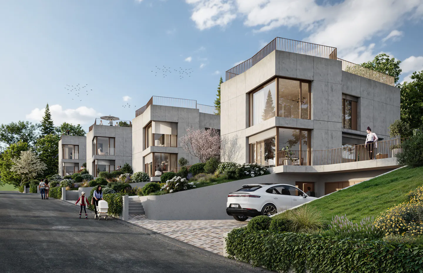 Modern concrete townhouses with large windows and rooftop terraces, surrounded by lush greenery and a white SUV parked nearby.