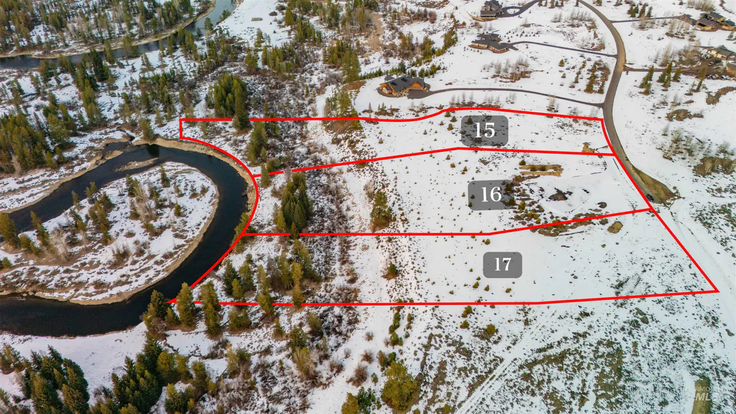 Aerial view of three snow-covered lots, numbered 15, 16, and 17, outlined in red, near a winding river and scattered trees.