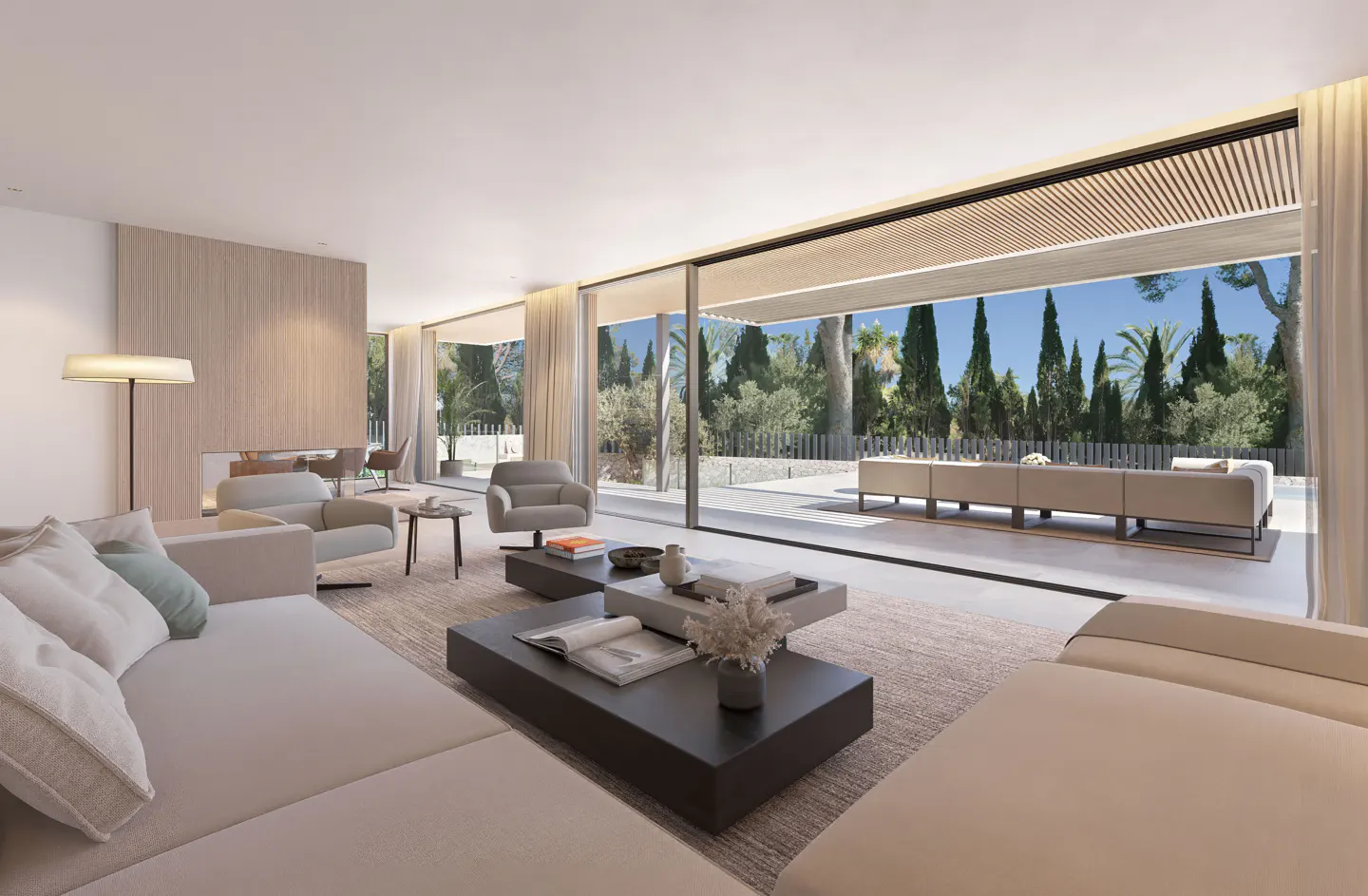 Bright, modern living room with beige sofas, dark coffee tables, and floor-to-ceiling windows overlooking a patio and lush greenery.