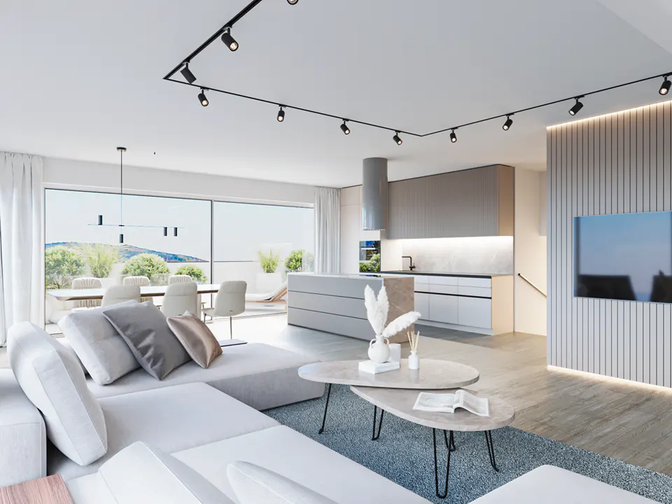 Bright, modern living space with a white sectional sofa, stone coffee tables, and an open kitchen with an island. Large windows offer a view of the outdoor dining area.