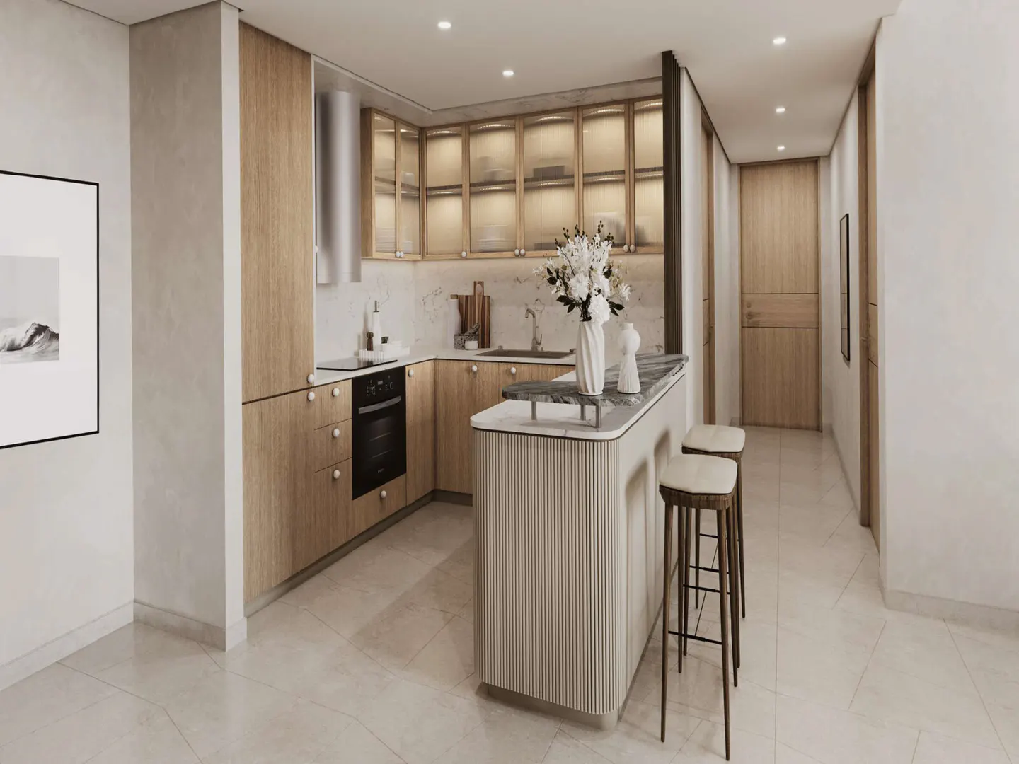 Modern kitchen with light wood cabinets, marble countertops, and a breakfast bar with two stools. A vase of white flowers sits on the counter.