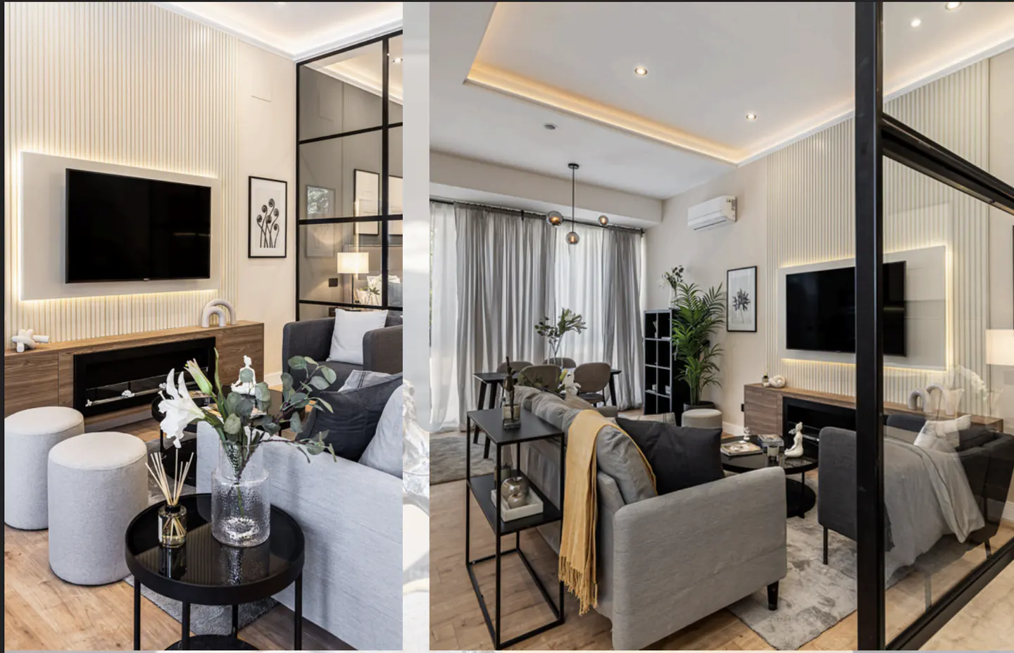 A modern living room with gray sofas, a black-framed glass partition, and a wall-mounted TV above a wooden cabinet. White flowers and decor add a touch of elegance.