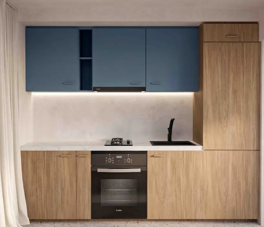 Modern kitchen with blue upper cabinets, wood-grain lower cabinets, black oven, cooktop, and sink. White countertop and backsplash.
