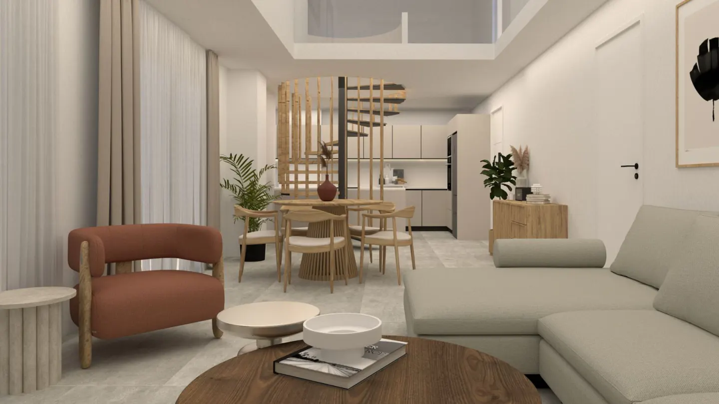 A bright, modern living space with a brown chair, a round wooden table, and a beige sectional sofa. A spiral staircase is visible in the background.