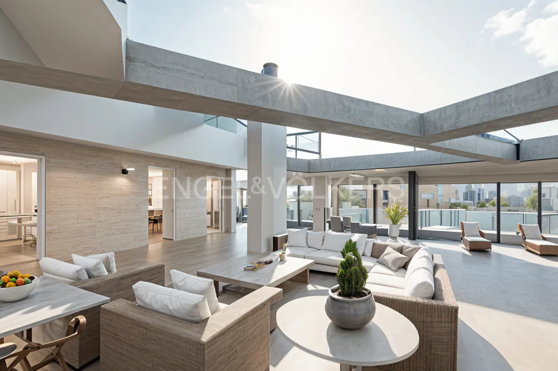 Bright, modern rooftop lounge with wicker furniture, white cushions, and potted plants. Concrete beams frame the open-air space with city views.