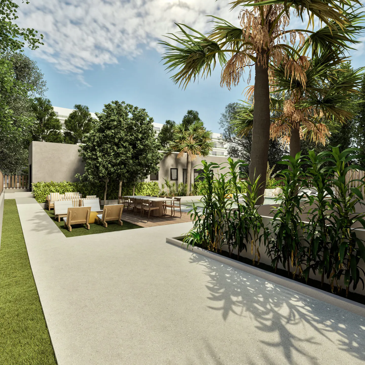 Outdoor patio with lounge chairs, table, and palm trees. The patio is surrounded by lush greenery and a concrete wall.