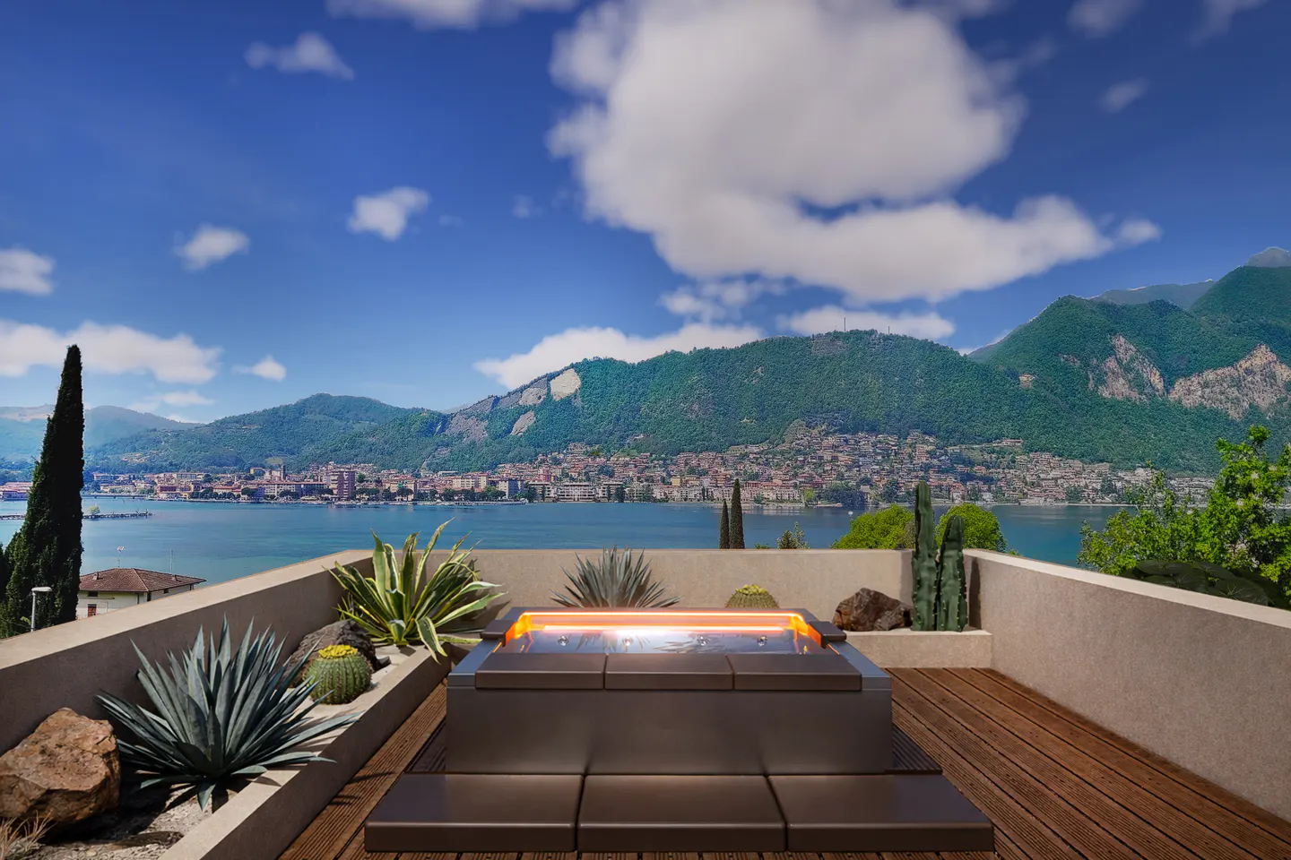 Rooftop deck with a hot tub, wood flooring, and a view of a lake and mountains under a blue sky with white clouds.
