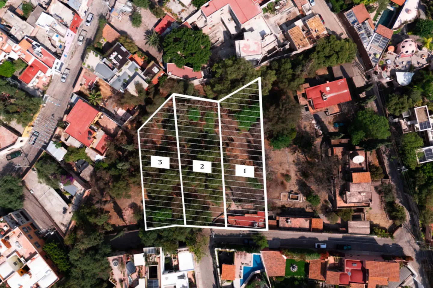 Aerial view of three adjacent plots of land, numbered 1, 2, and 3, surrounded by houses and trees.