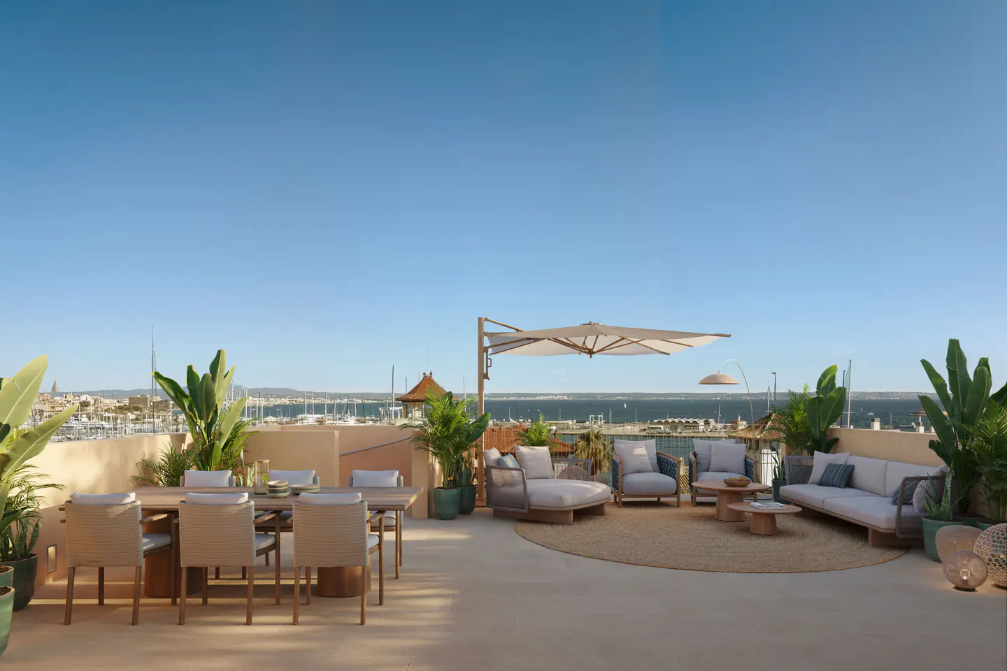 Sunny rooftop terrace with dining area, lounge seating, large umbrella, and potted plants overlooking a harbor and sea.
