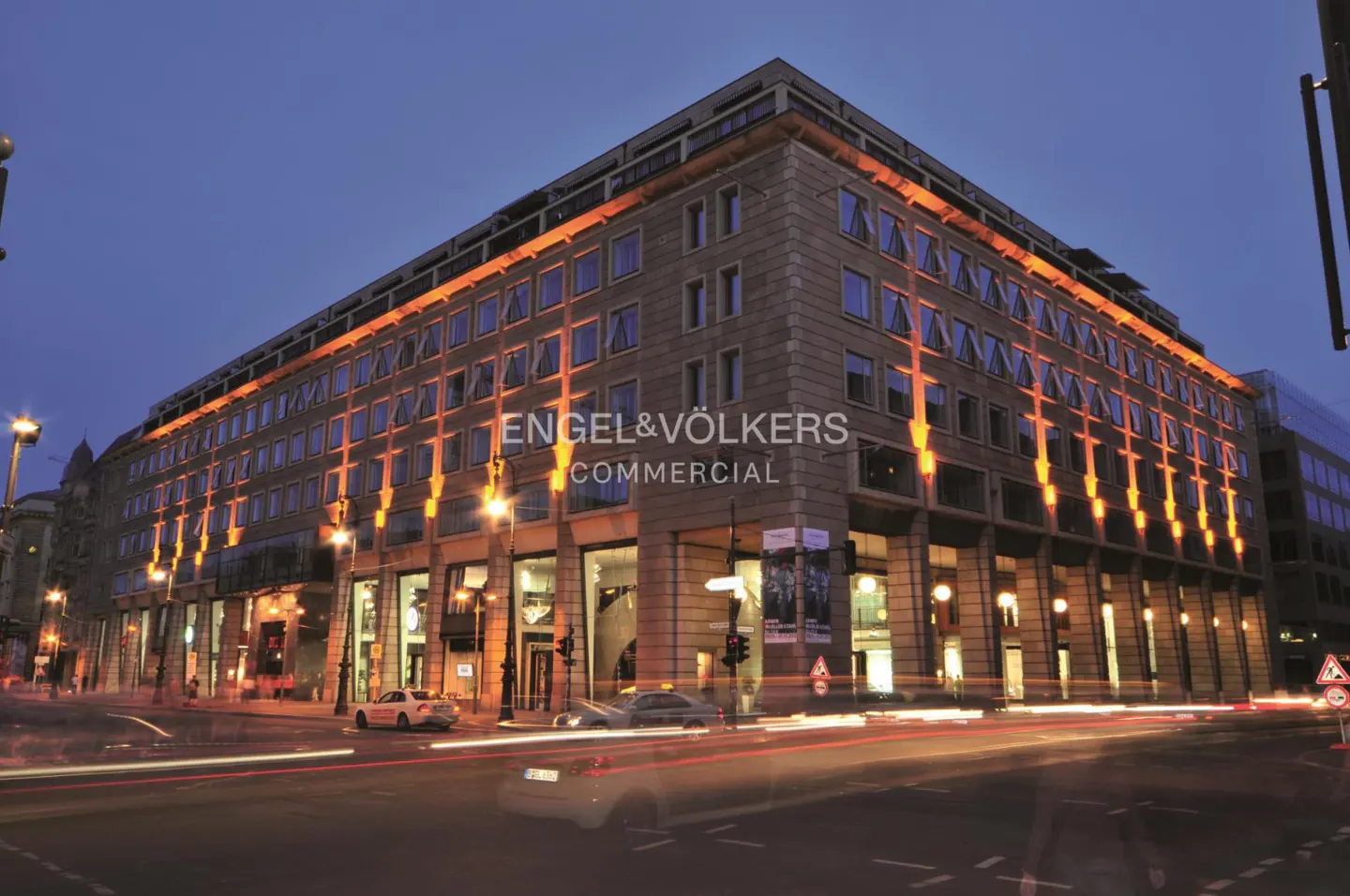 Engel & Völkers Commercial building at dusk, with light trails from passing cars.