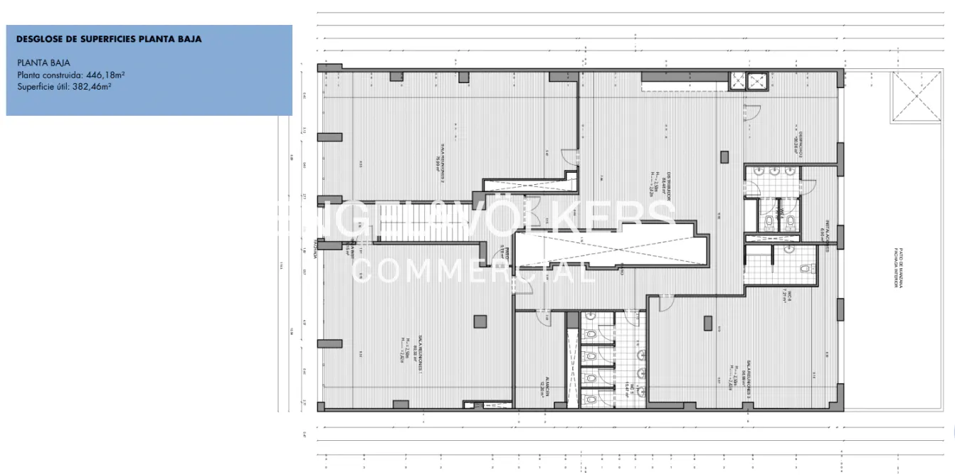 Floor plan of a commercial building's ground floor, showing layout of offices, restrooms, and stairwell. The plan is in black and white.