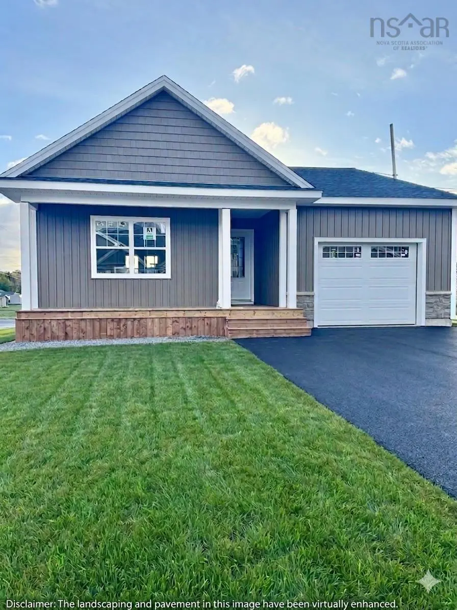 A gray, one-story house with a white garage door, porch columns, and green lawn.