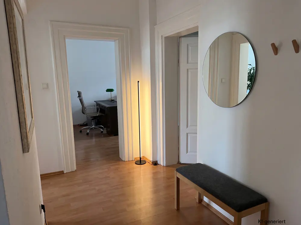 Bright hallway with wood floors, a bench, a round mirror, and a view into an office with a desk and chair.