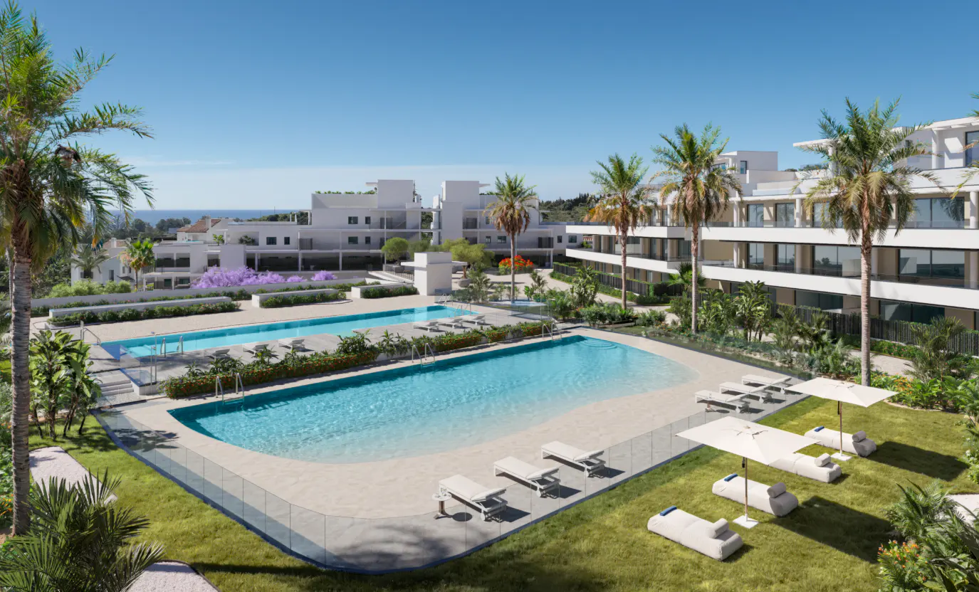 Aerial view of a luxury resort with pools, white buildings, palm trees, and lounge chairs under a clear blue sky.