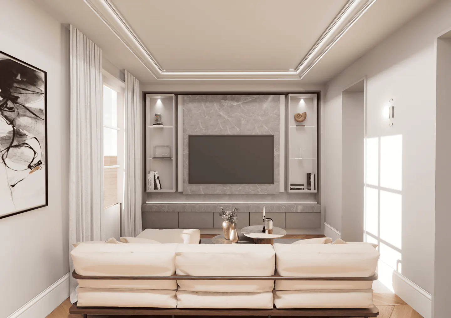 Living room with a cream sofa, TV, and built-in shelves. The walls are light gray, and there is a large black and white painting on the left wall.
