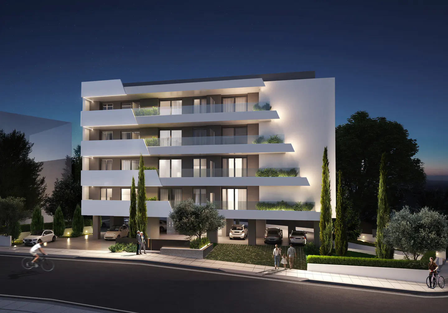 Modern four-story apartment building at night with illuminated balconies, covered parking, and landscaped surroundings.