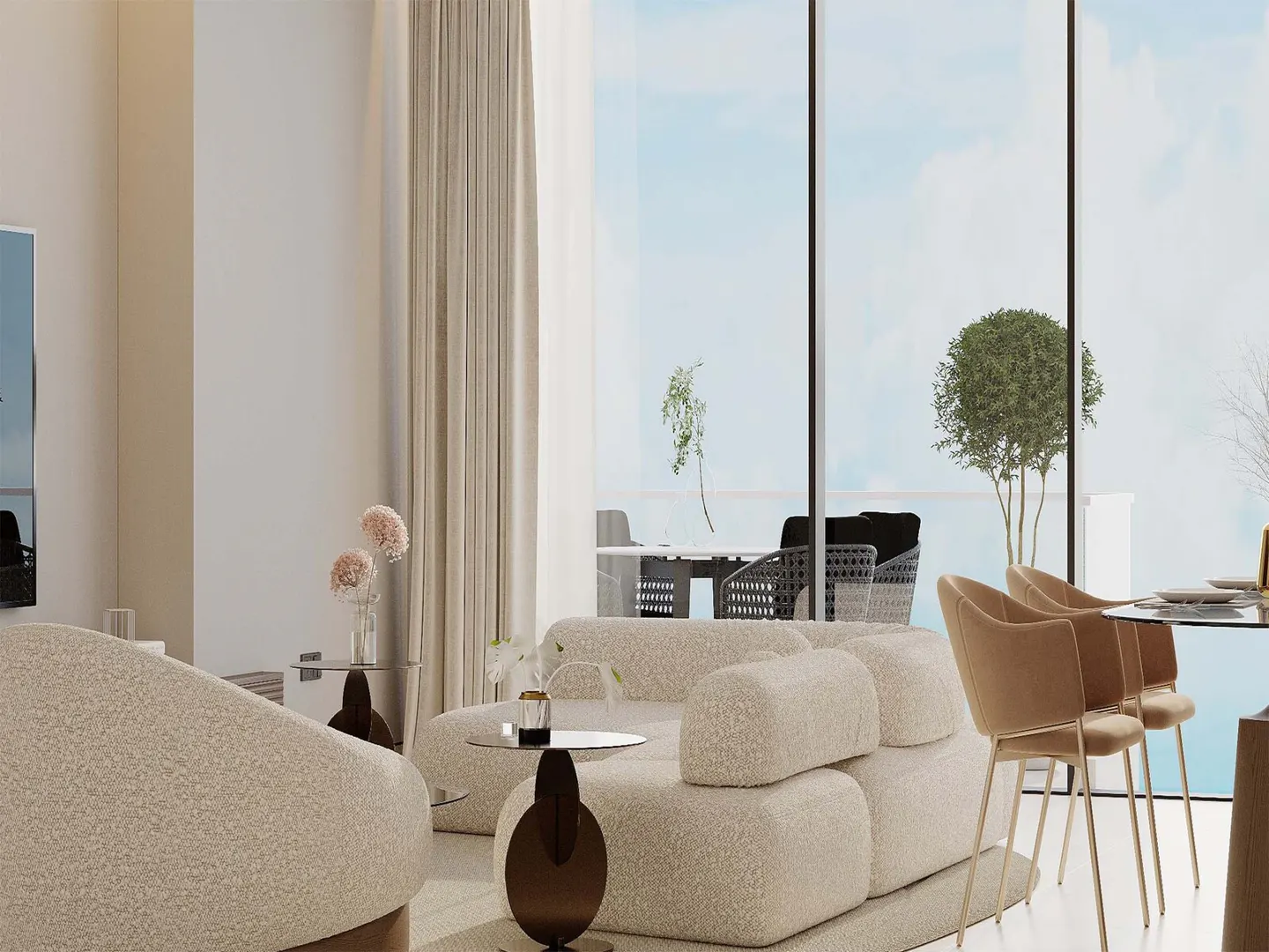 Living room with a beige sofa, chairs, and a glass table. Large windows offer a view of the ocean and a patio with outdoor furniture.