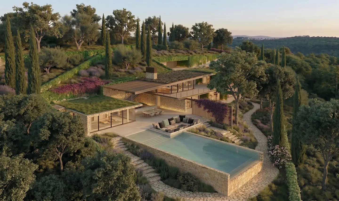 Luxury home with a pool on a hillside. Stone house with a green roof, outdoor seating, and lush landscaping.