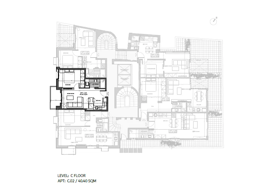 Architectural floor plan of a building, with one apartment highlighted in black. The apartment includes a bedroom, living room, and kitchen.