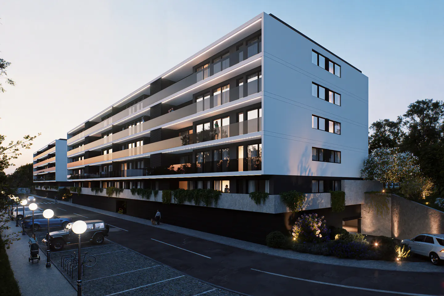 Modern apartment building with white facade and glass balconies, street parking, and landscaping at dusk.
