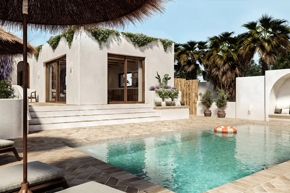 Exterior view of a white villa with a pool, palm trees, and a thatched umbrella. A red and white life preserver floats in the pool.
