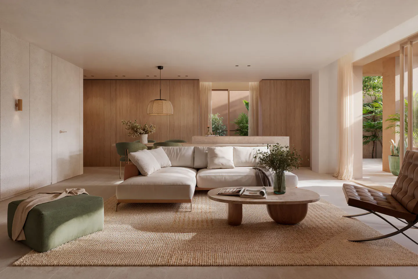 Modern living room with a white sectional sofa, round wooden coffee table, green ottoman, and brown leather accent chair.