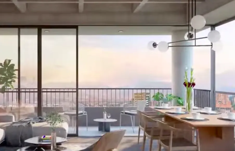 Modern apartment interior with a dining table set for six, a living area, and a balcony overlooking a city skyline.