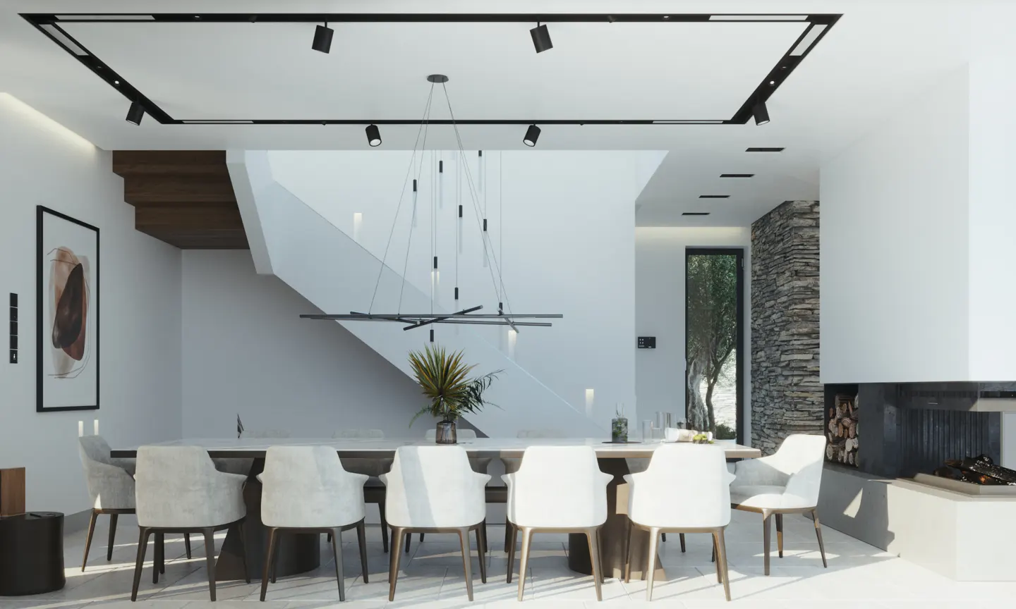 Bright dining room with white chairs around a long table, modern lighting, and a stone fireplace.